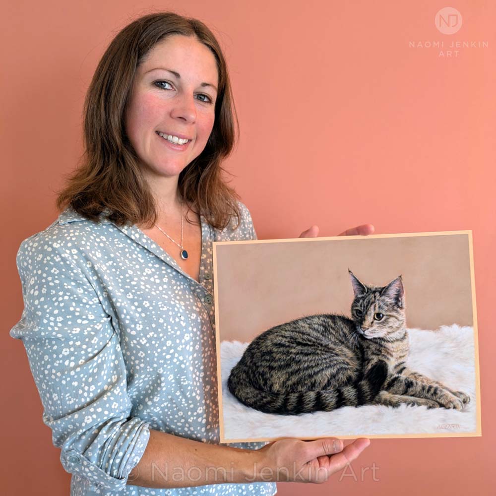 Cat portrait artist Naomi Jenkin with her hand drawn pet portrait of Mrs Tibbs the cat.