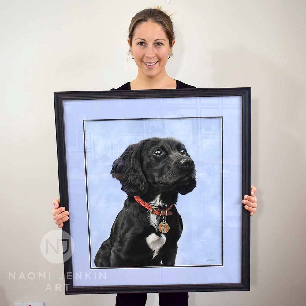 Naomi with the framed portrait of Mabel the cocker spaniel