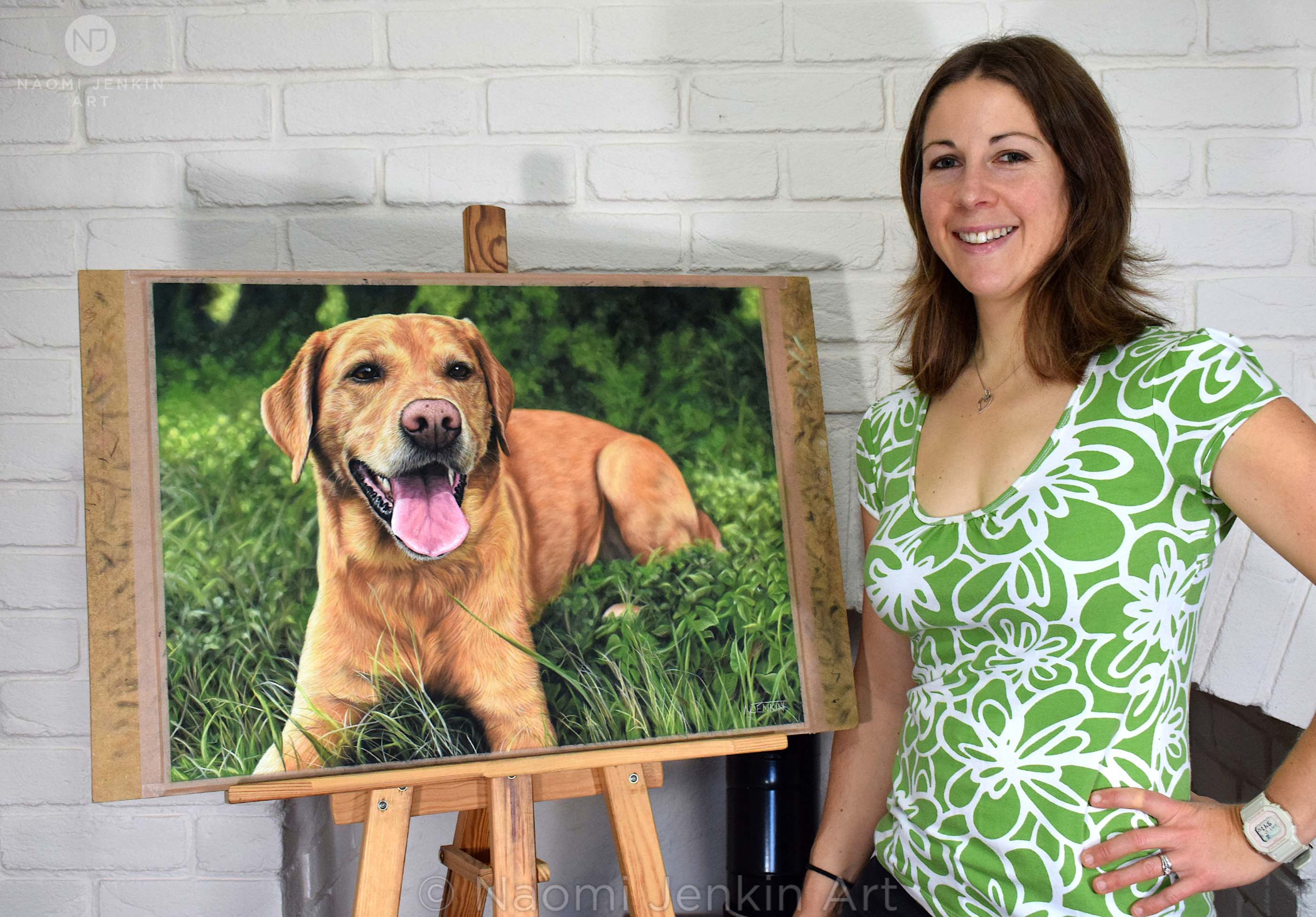 Naomi Jenkin with her pastel pet portrait of fox red Labrador, Mylo