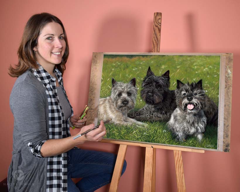 Pet portrait artist Naomi Jenkin with her portrait of three Cairn Terriers