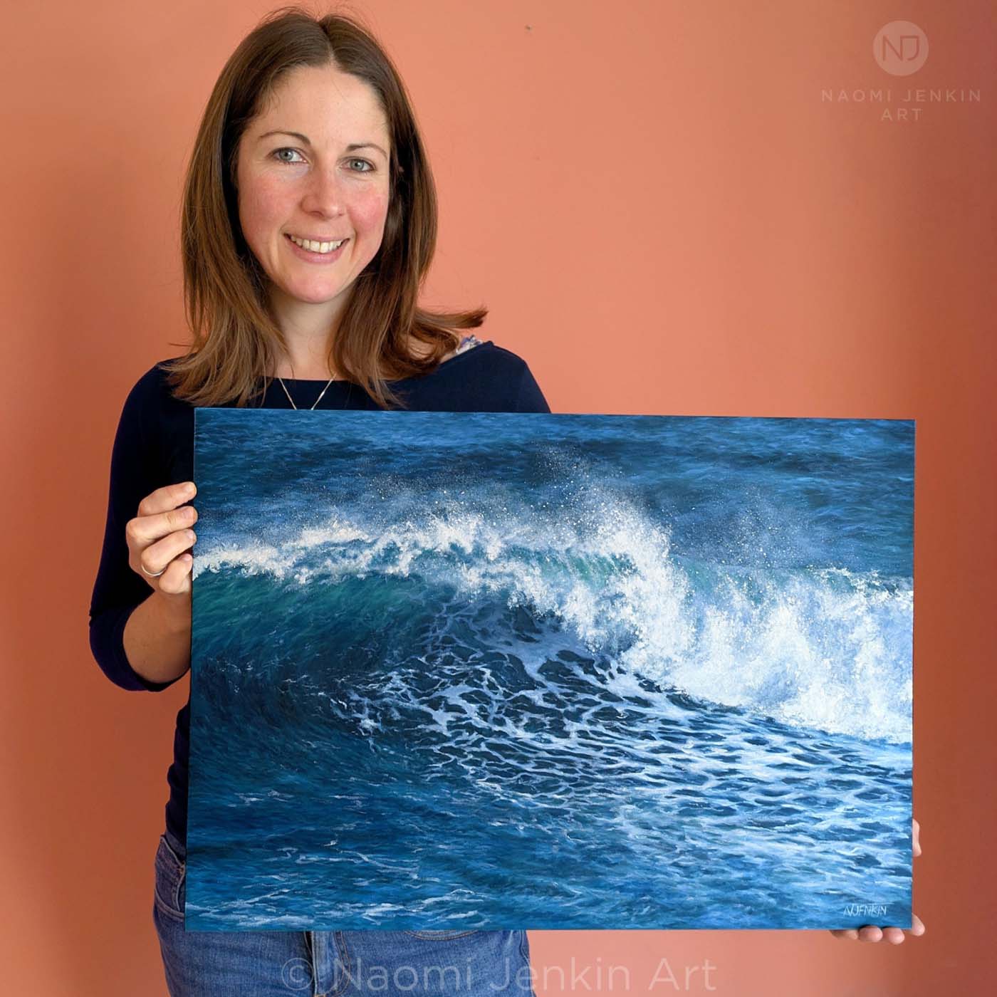 Seascape artist Naomi Jenkin with her wave painting 
