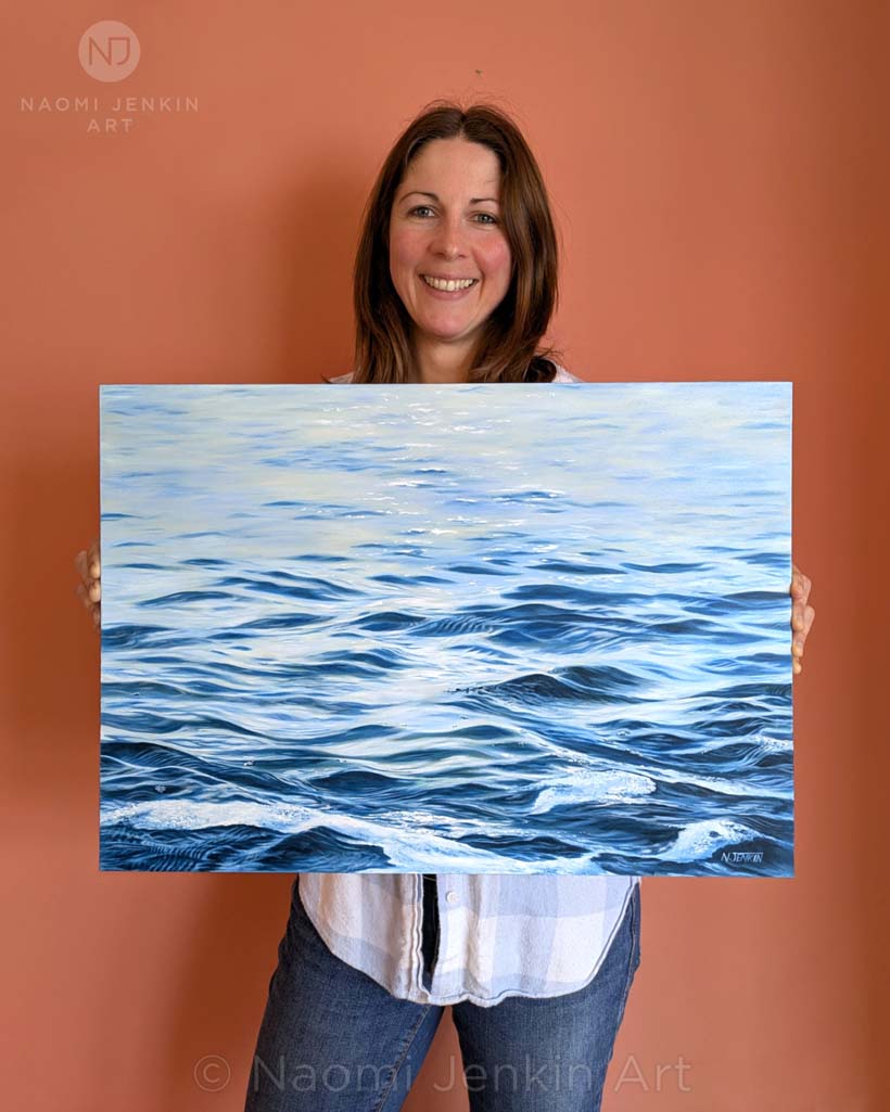 Seascape artist Naomi Jenkin with her calm reflections painting titled "Serenity".