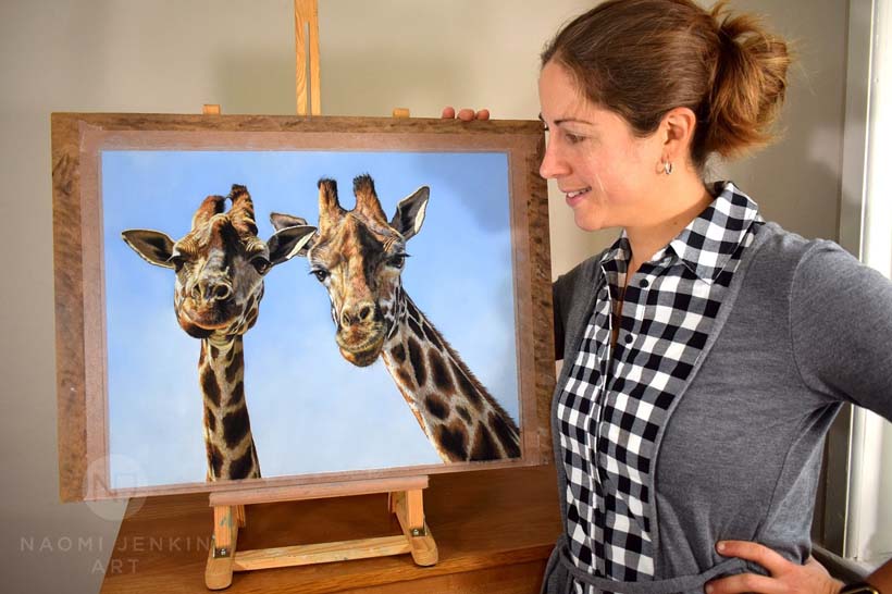 Wildlife artist Naomi Jenkin with giraffe painting. 