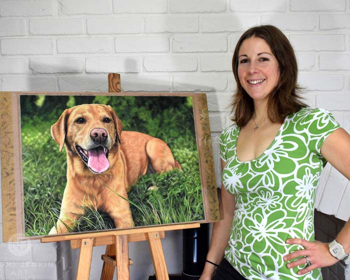 Pet portrait artist Naomi Jenkin with dog portrait of a Labrador.